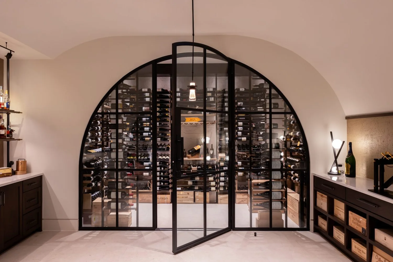 A glass-fronted wine room set into an arched opening